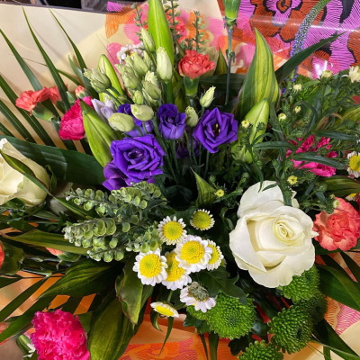 Springtime Splendor Bouquet - A bright and cheerful bouquet that combines fresh greens with pops of vivid colour, evoking the joyful spirit of spring. flower types are subject to seasonal availability and will be substituted on a florist choice basis.