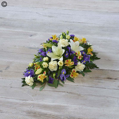 Lemon and Blue Spray - One of our most popular designs, this teardrop shaped arrangement features stunning lemon and blue blooms including irises, lisianthus, and alstroemeria. 

Approximate Product Dimensions:
Standard:
Length: 55cm, Width: 28cm, Height: 20cm.

Large:
Length: 60cm, Width: 30cm, Height: 25cm.

Extra large:
Length: 70cm, Width: 35cm, Height: 25cm.