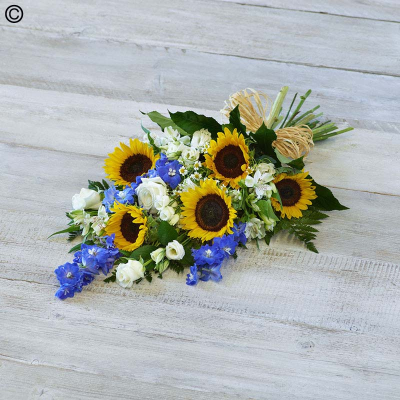 Sunflower Medley Sheaf - A gorgeous summery medley featuring warm sunflowers, bright blue delphiniums and white roses.

Approximate Product Dimensions:
Standard:
Length: 60cm, Width: 30cm, Height: 15cm.

Large:
Length: 70cm, Width: 30cm, Height: 15cm.

Extra large:
Length: 80cm, Width: 40cm, Height: 15cm.