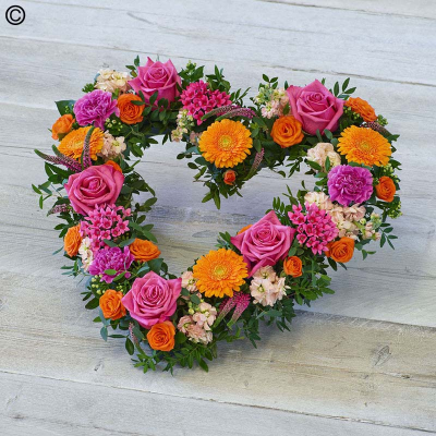 Bold Brights Heart - A vibrant combination of blooms including roses, carnations, and stocks, in a beautiful open heart design.

Approximate Product Dimensions:
Length: 44cm, Width: 48cm, Height: 12cm.