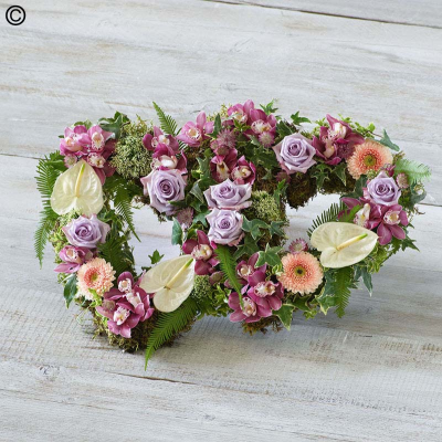 Deluxe Double Heart - Two beautiful hearts with an open design, each features the finest orchids, anthuriums, and delicate lilac roses nestled in fresh foliage.

Approximate Product Dimensions:

Length: 38cm, Width: 60cm, Height: 15cm.