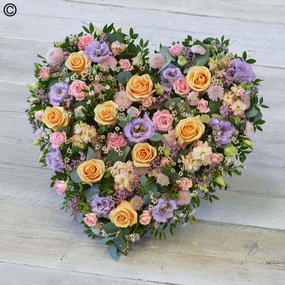 Pastel Rose Heart - A heart tribute of pretty pastel shades featuring roses, limonium, chrysanthemum and fragrant stocks.

Approximate Product Dimensions:
Length: 44cm, Width: 48cm, Height: 12cm.