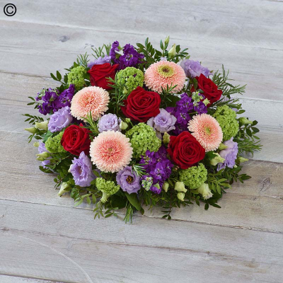 Rose and Germini Posy - A combination of vibrant roses, soft peach germini and lavender lisianthus, this posy of rich tones also features fragrant stocks.

Approximate Product Dimensions:
Width: 38cm, Height: 15cm.