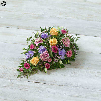 Scented Pastels Spray - A profusion of fragrant pastel blooms arranged in a teardrop shape. Features scented freesia, peach roses, and natural willow and grass. 

Approximate Product Dimensions:
Standard:
Length: 50cm, Width: 30cm, Height: 18cm.

Large:
Length: 52cm, Width: 30cm, Height: 18cm.

Extra large:
Length: 55cm, Width: 30cm, Height: 18cm.