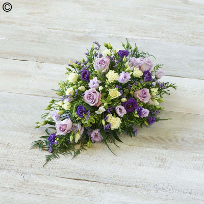 Petite Spray - A delicate mix of blooms including roses, lisianthus and scented silvery rosemary. Arranged in a teardrop shape suitable for smaller coffins.

Approximate Product Dimensions:
Length: 52cm, Width: 32cm, Height: 18cm.