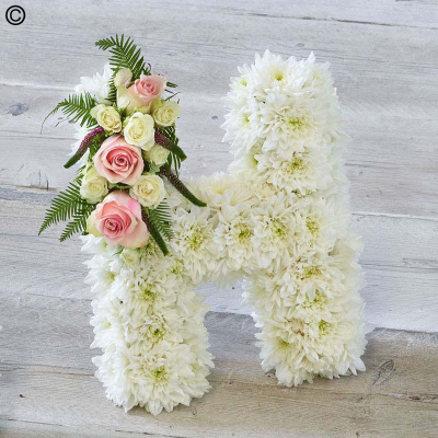 Funeral Lettering with fresh flowers - Our funeral letters allow for personalized spelling, ensuring that your tribute reflects the exact wishes of the loved one. Choose from white double white Chrysanthemums or variety